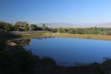 Adams_Falls_009_05272017 - Looking down over a reflective pool early in the morning towards the US89 and some snowy mountains in the distance in the direction of Antelope Island