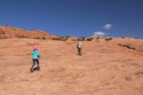Arches_NP_181_04192017 - Julie and Tahia continuing to use people up ahead as sort of hints for us on where to go next on this slickrock part of the Delicate Arch Trail