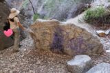 Bailey_Canyon_069_02062016 - Julie walking past a graffiti-covered rock near Bailey Canyon Falls