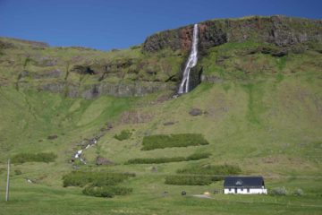 Bjarnafoss is a tall waterfall tumbling right behind the small farming hamlet of Buðir.  It has been said that under the waterfall stands the 