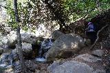 Black_Star_Canyon_Falls_122_01082023 - Mom climbing over more boulders alongside a small cascade on Black Star Creek