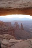 Canyonlands_17_052_04212017 - Looking through Mesa Arch towards Washer Woman Arch and Monster Butte not long after the sun breached the clouds over the La Sal Mountains in the distance