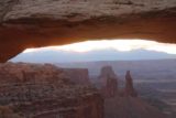 Canyonlands_17_056_04212017 - Broad off-center look (to avoid the tripods, heads, and cameras in the photographers line) through Mesa Arch towards Washer Woman Arch and Monster Butte