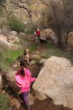 Cedar_Creek_Falls_101_01072017 - Tahia getting over a couple of rock obstacles near the end of the Cedar Creek Falls hike with a dog looking on during our January 2017 hike