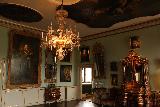 Copenhagen_308_07282019 - Passing through another ornate room full of portraits, fancy furniture, and ceiling decorations at the Rosenborg Castle in Copenhagen