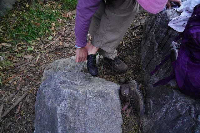 Mom changing out of water shoes, which she opted to use for a hike that involved numerous knee-deep river crossings