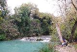 Diborrato_037_11192023 - Context of looking upstream along the River Elsa towards the local angler by some travertine cascades just above the Cascata del Diborrato