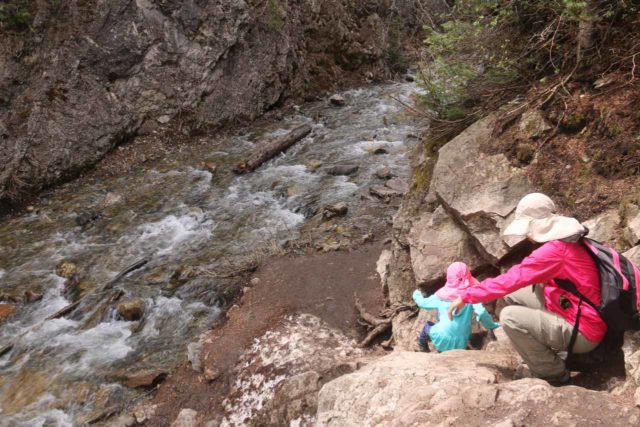 Donut_Falls_053_05262017 - Tahia and Julie negotiating a little bit of a sit and scoot scramble in order to access the Mill D South Fork Creek towards Donut Falls