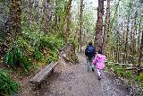 Drift_Creek_Falls_021_04082021 - Julie and Tahia going by a bench alongside the Drift Creek Falls Trail