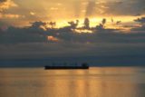 Duluth_144_09282015 - Closeup of the barge with rising sun hidden behind the morning clouds