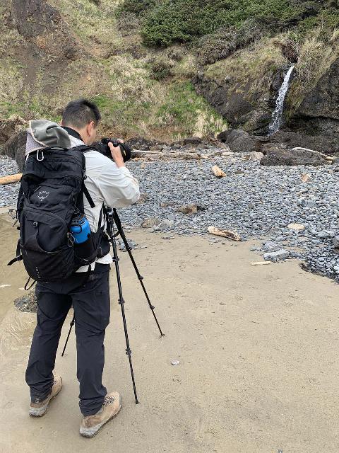 Setting up the camera on the Manfrotto BeFree 3-Way Live Advanced tripod at a beach waterfall, which required a bit of a muddy and steep hike to reach