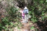 Falls_Canyon_Falls_036_02212016 - Julie and Tahia trying to dodge poison oak along the trail-of-use within Falls Canyon