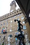 Florence_418_11212023 - Looking up across the copper Medusa beheading statue towards the Palazzo Vecchio in Piazza della Signoria