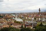 Florence_738_11222023 - The classic panoramic view of Firenze with the Arno River going under the Ponte Vecchio and the towers and Duomos and red roofs to the right of them as seen from the Piazzale Michelangelo