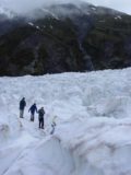 Franz_Josef_helihike_058_11222004 - Context of other helihike participants standing atop parts of the jagged ice of Franz Josef Glacier as seen in November 2004