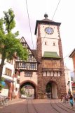 Freiburg_137_06212018 - The clock tower and a pair of archways or gates in Freiburg im Breisgau