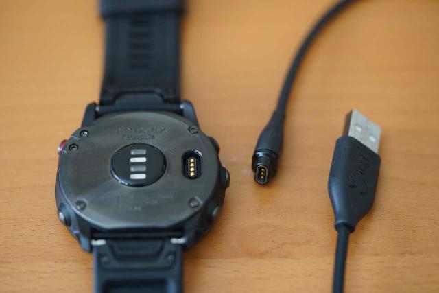 The backside of my Garmin Fenix 6X Pro Sapphire watch with its USB interface and accompanying stock cable