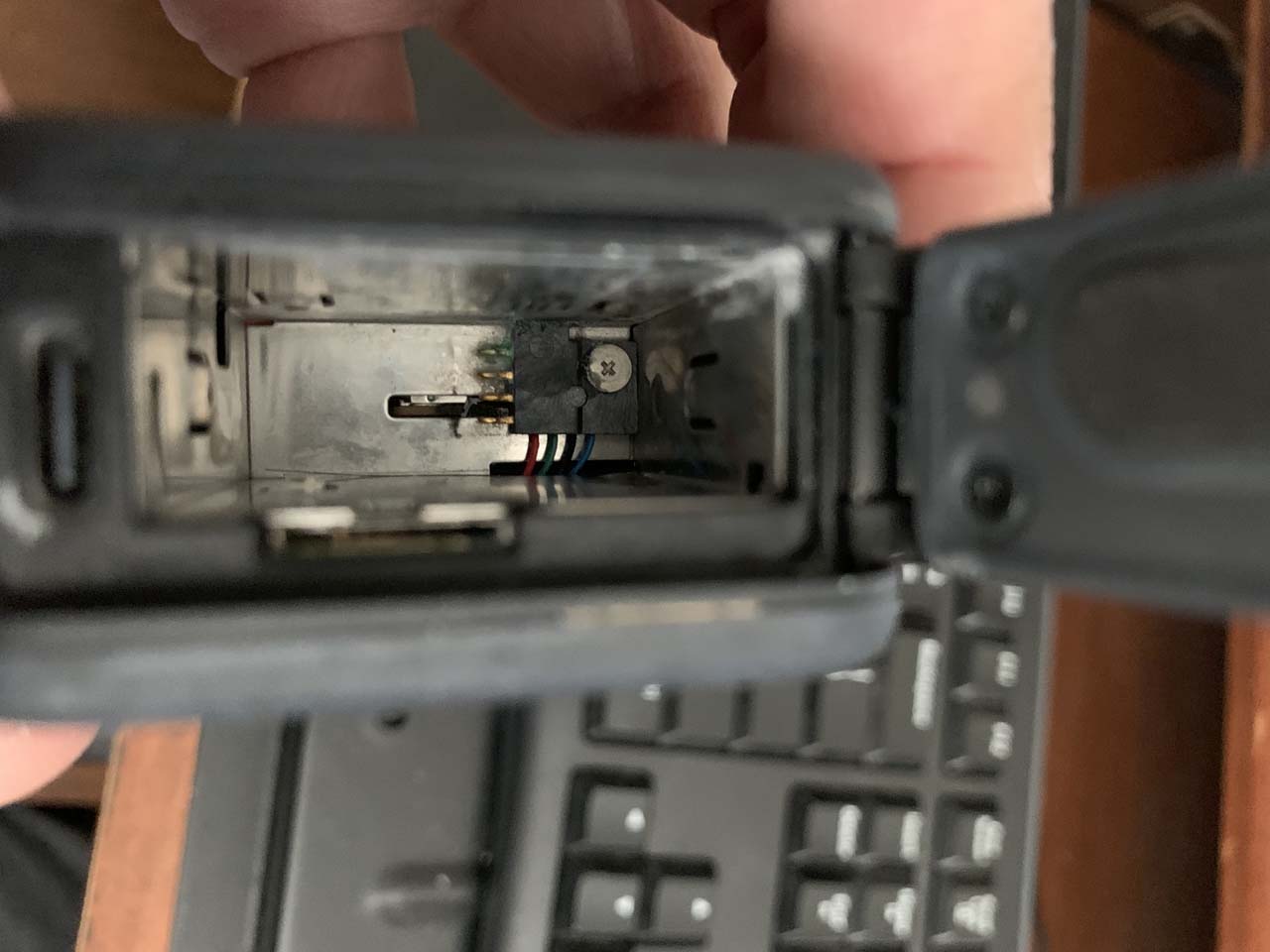 Looking inside the battery compartment of my GoPro HERO 9 Black that had been water damaged during use while snorkeling