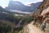 Grinnell_Glacier_338_08072017 - Following along a narrow ledge part of the Grinnell Glacier Trail with the Grinnell Falls profile in the distance