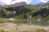 Grossglockner_189_07122018 - Looking across the reservoir past a couple checking out the Nassfeld Waterfall
