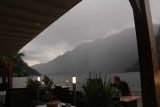 Hallstatt_675_07052018 - One of the staff members at the Seehotel Gruner Baum scrambling to get the tables and chairs out of harms way as there was an incoming cloudburst about to dump on Hallstatt