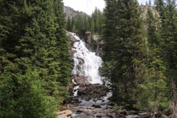 Hidden Falls was a satisfying 75-100ft waterfall at the far end of the scenic Jenny Lake, which fronted the signature skyline of the Grand Teton Range.  To our knowledge, this was the most...
