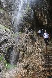 Hollentalklamm_178_06262018 - Context of people coming down the steps beneath the side waterfall spilling past the Hoellentalklamm Trail