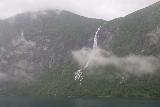 Hurtigruten_day2_411_06302019 - Another look back at Ljosurfossen partially shrouded by a low strand of storm cloud in Geirangerfjorden