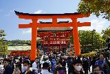 Kyoto_176_04082023 - Approaching a torii gate fronting the Fushimi Inari Taisha Shrine complex amongst a sea of people