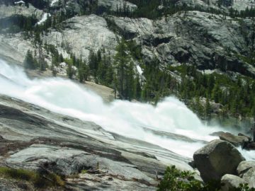 LeConte Falls starts off as mostly a long series of featureless cascades until its main drop.  In its main drop, the Tuolumne River slides down a fifty-degree slope with potholes backed by rocks...