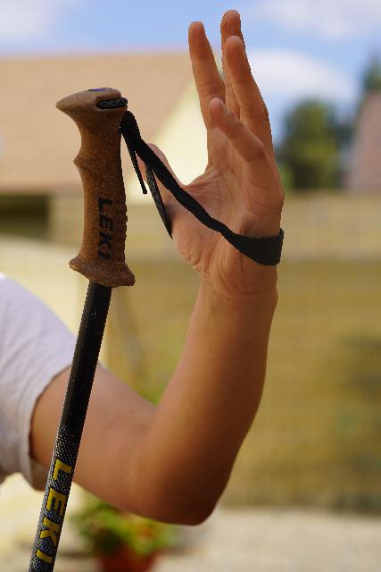 Putting my hand through the bottom of the wrist-strap's loop, which is the first step in properly gripping a trekking pole