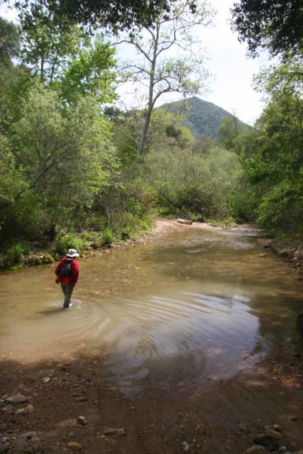 Mom changing out of water shoes, which she opted to use for a hike that involved numerous knee-deep river crossings