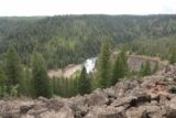 Lower_Mesa_Falls_17_008_08142017 - Panoramic look past some loose volcanic boulders towards a partial view of the Lower Mesa Falls