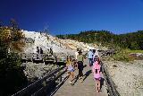 Mammoth_Hot_Springs_019_08042020 - Julie and Tahia along with other people walking on the Lower Terrace Boardwalk at Mammoth Hot Springs in August 2020