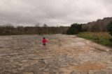 McKinney_Falls_015_03102016 - Tahia walking across the wide rocky section while splashing in some of the shallow puddles