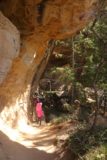 Mesa_Verde_104_04162017 - Julie and Tahia passing beneath one of several large overhangs and alcoves along the Petroglyphs Trail in Mesa Verde National Park