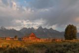 Mormon_Row_055_08132017 - More zoomed out look at the Moulton Barn fronting the shadowed Grand Tetons at sunrise