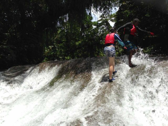 We typically use reef shoes for tropical destinations since they pack light and we would frequently encounter watery adventures like this one at the Mt Hope Waterfall in Vanuatu