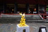 Nikko_025_04142023 - Some gold rabbit fronting a worshipping area for the Nikko Futarasan Jinja Shrine on a rainy day