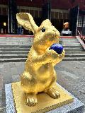 Nikko_Shrines_001_jx_04152023.JPEG - More closeup look at a golden rabbit statue fronting a shrine building at the Nikko Futarasan Jinja Shrine on a rainy day