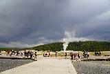 Old_Faithful_037_08032020 - Looking back at the context of Old Faithful Geyser after the eruption event while the crowd was dispersing from the viewing area under incoming dark clouds