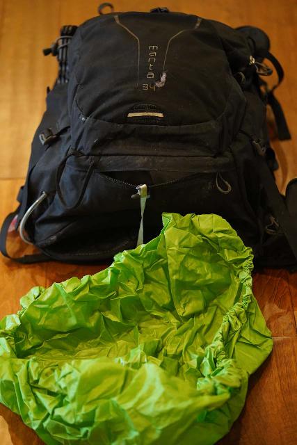 The Osprey Manta 34 includes a rain cover hidden in the underbelly of the backpack