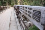 Ousel_Falls_127_08082017 - Looking along the railing of the first bridge over West Fork Gallatin River showing small plaques of the names of donors