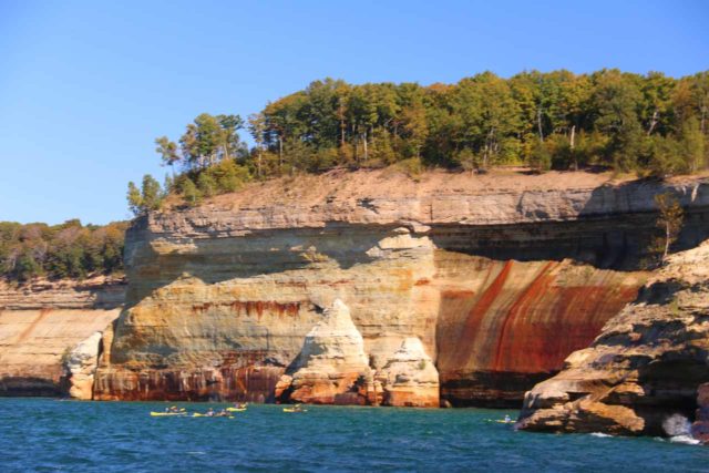 Pictured_Rocks_cruise_152_09302015 - Looking towards kayakers getting close to some of the namesake Pictured Rocks seen along the Pictured Rocks Cruise en route to Spray Falls