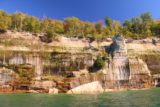 Pictured_Rocks_cruise_251_09302015 - More jumbled patterns and fallen rocks lining the Pictured Rocks with some fall colors showing on the tree-lined rim
