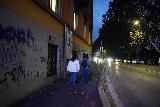 Rome_307_11162023 - Julie and Tahia walking along some graffiti-laced buildings towards the Church of St Bartholomew