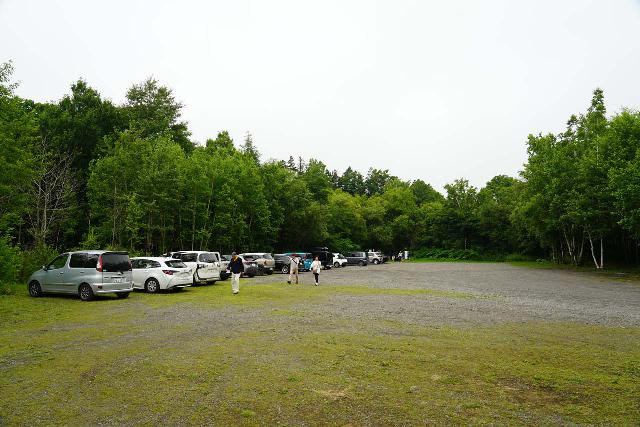 Sakura_Falls_005_07162023 - Looking across the large unpaved clearing acting as the car park for the Sakura Falls, which was surprising busy when we showed up in mid-July 2023