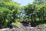 Saleaula_Lava_Fields_033_11152019 - Julie continuing to walk from the missionary church towards the lagoon and lava cliffs of the Saleaula Lava Fields in Savai'i