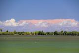 Saleaula_Lava_Fields_050_11152019 - Another look across the green lagoon towards some mysteriously pink thunderclouds at the Saleaula Lava Fields in Savai'i