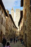 San_Gimignano_015_11202023 - Portrait view of the alleyway looking towards a second tower in the background en route to the center of San Gimignano